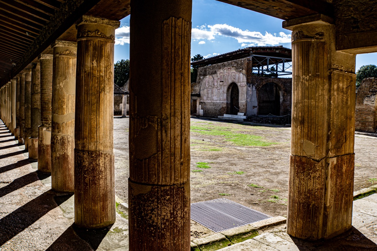 The Forum of Pompeii with ancient columns and Mount Vesuvius