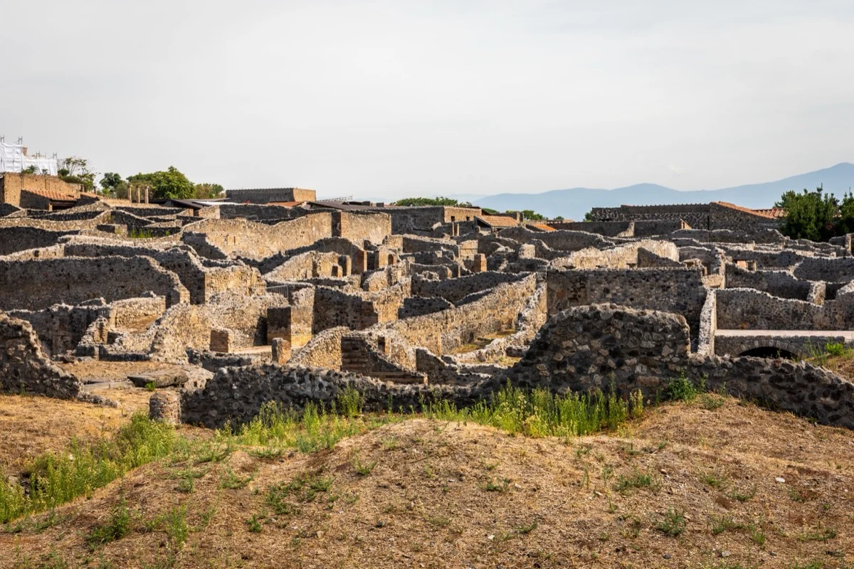 Aerial view of ancient Pompeii ruins with Mount Vesuvius in the background